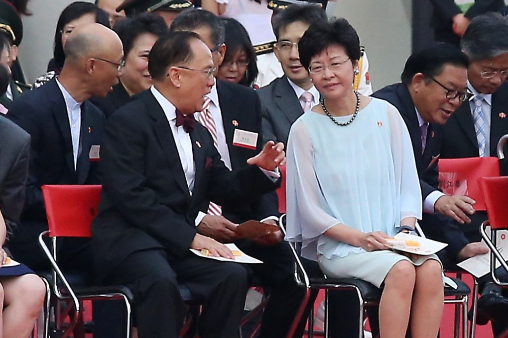 Former Hong Kong chief executive Donald Tsang speaks to then chief secretary Carrie Lam during a flag-raising ceremony to celebrate the 66th anniversary of the founding of the People’s Republic of China, at the Golden Bauhinia Square in Wan Chai on October 1, 2015. Photo: K.Y. Cheng