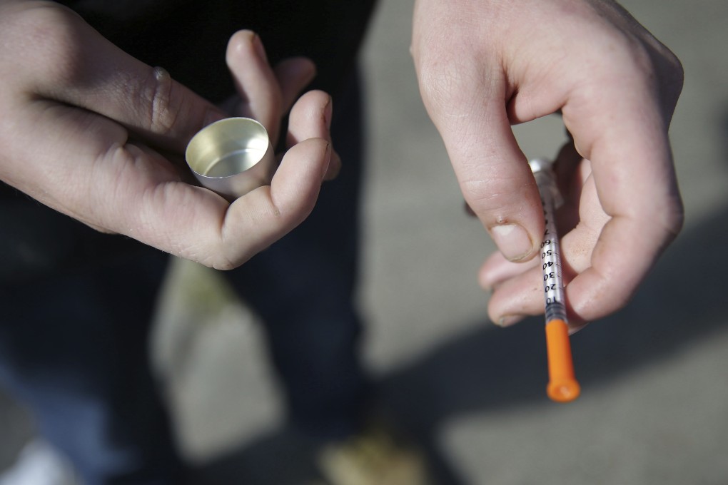 A US fentanyl user holds a needle used to inject the drug. Photo: AP