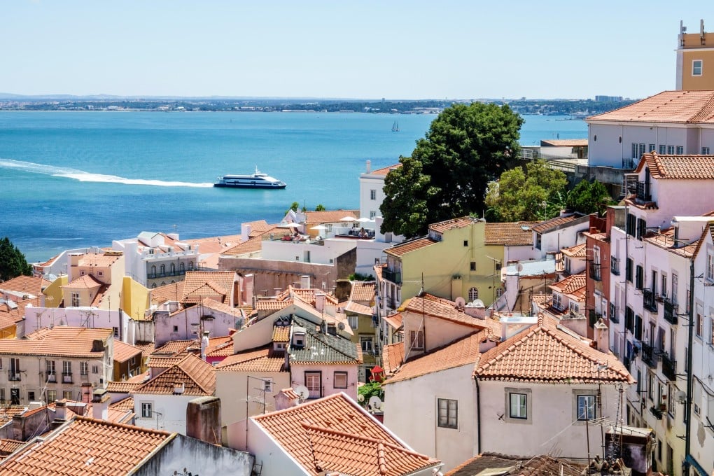 The view of Lisbon’s Alfama neighbourhood and Tagus river from the Miradouro das Portas do Sol observation deck. Photo: Alamy