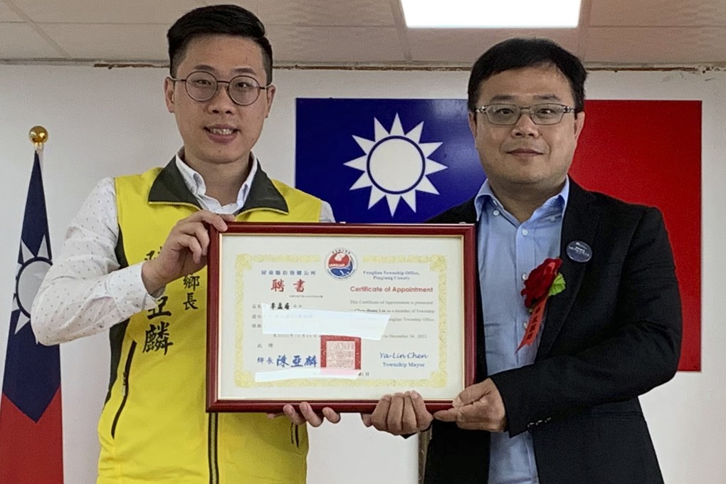 Lee Meng-chu (right) receives a certificate for his work with the Fangliao township in Taiwan from mayor Chen Ya-lin in June. Photo: AP