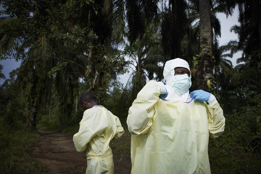 Health workers equip themselves in protective equipment in Beni, North Kivu province. Photo: EPA-EFE
