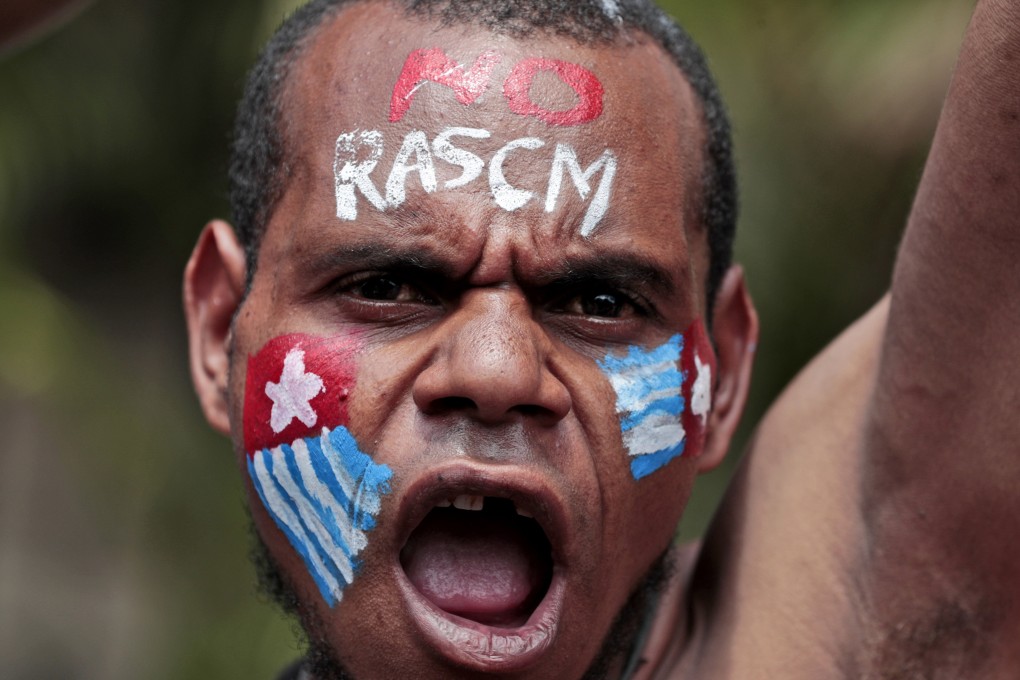 A Papuan activist with his face painted with the colours of the separatist Morning Star flag during a rally in Jakarta. Photo: AP