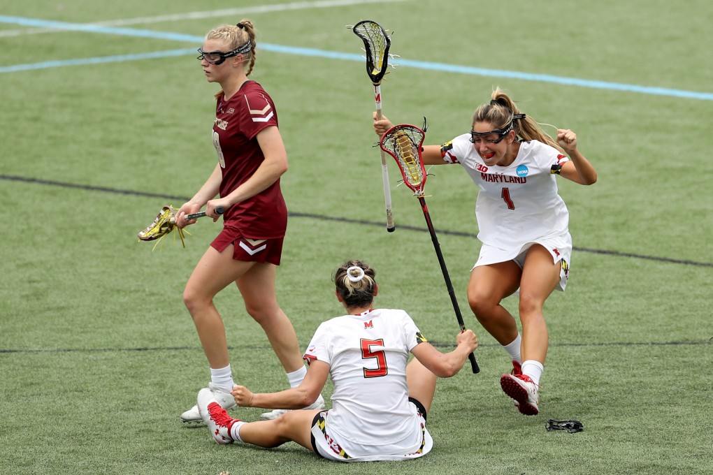 Lacrosse equipment and other sporting goods are facing increased tariffs. Pictured, Brindi Griffin (right) of the University of Maryland celebrates with Jen Giles (5) after Giles scored against Boston College on May 26. Photo: Getty Images/Agence France-Presse