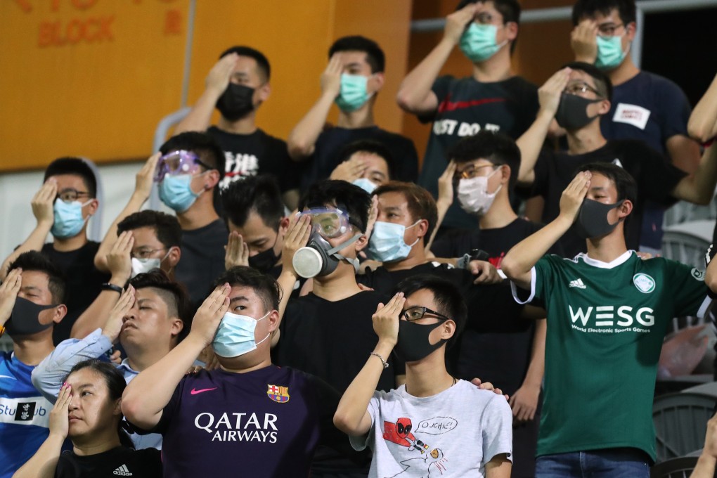 Fans stand in silence, in support of the recent anti-extradition protests, during the Kitchee v Happy Valley match at Mong Kok Stadium. Photo: K.Y. Cheng