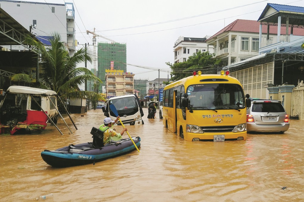 Submerged cars, buses and motorbikes were abandoned throughout the city during heavy flooding in Sihanoukville, Cambodia, early last month. Photo: Mother Nature