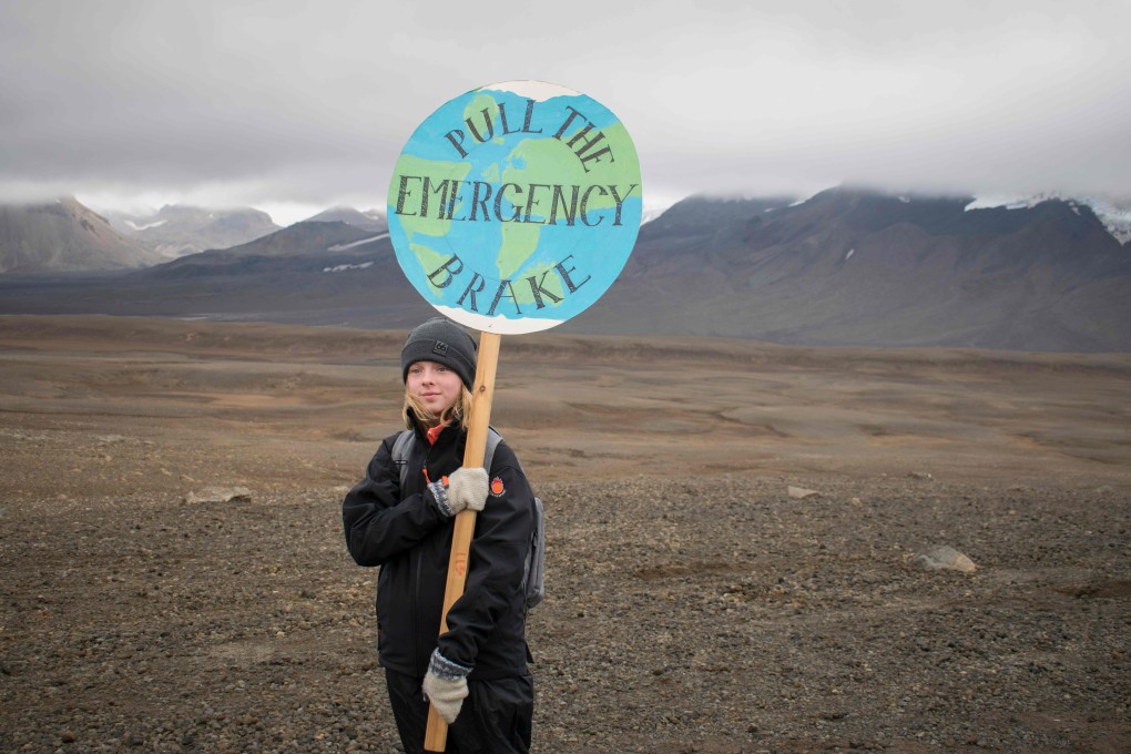 An Icelandic girl at the site of Okjokull, Iceland's first glacier lost to climate change, on August 18. To complete the transition from fossil fuels requires drilling down to the core of the global economy. Photo: AFP