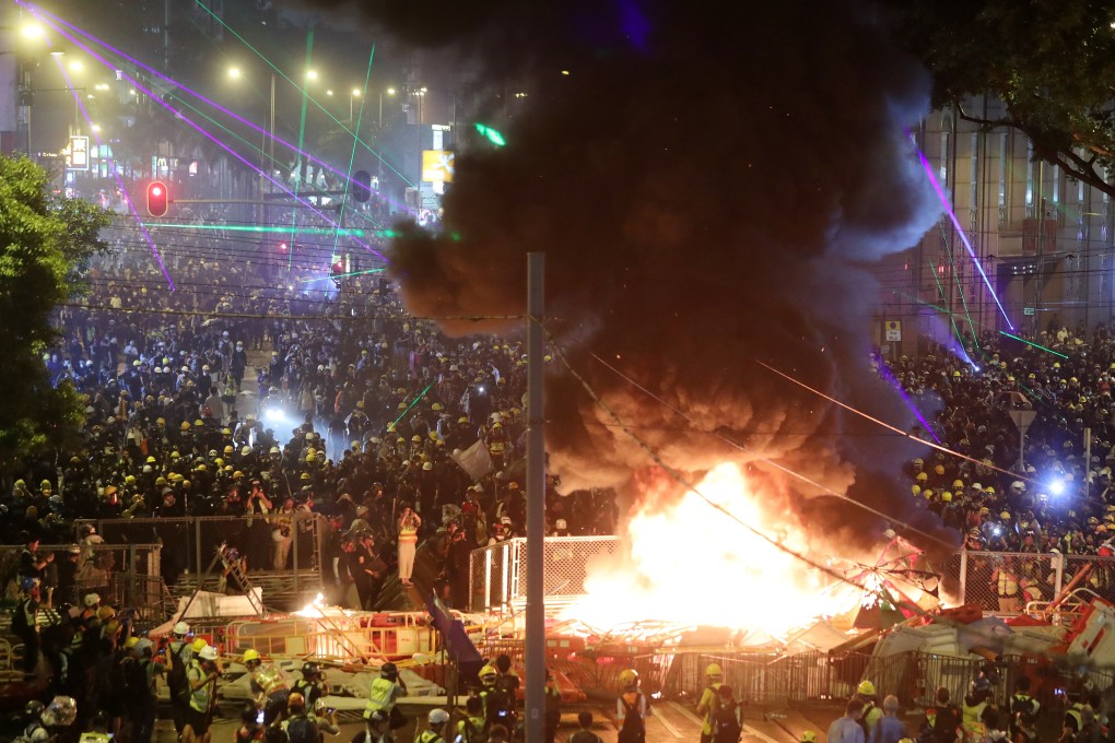 Anti-government protesters set barricades on fire on Hennessy Road, in Wan Chai. Photo: Sam Tsang