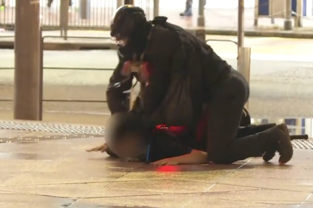 An undercover police officer subdues a protester in Causeway Bay on Saturday. Photo: RTHK