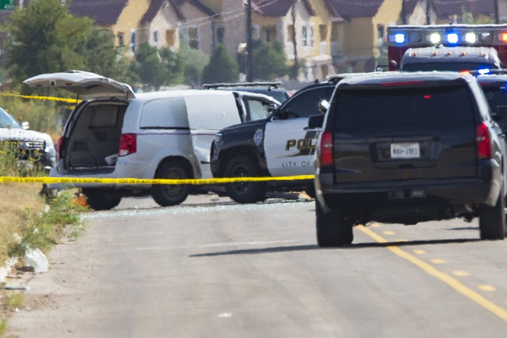 Police surround a white van after the mass shooting in Odessa, Texas. Photo: AP