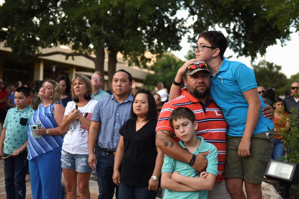 People gather for a vigil following Saturday’s shooting in Odessa, Texas. Photo: Reuters