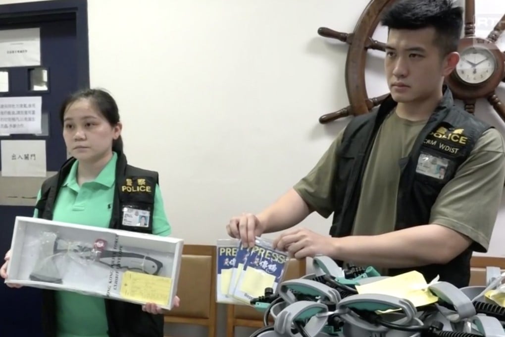 Police show press badges and various other gear confiscated from National Disaster Hardware Shop’s Sai Ying Pun pop-up storefront. Photo: Handout