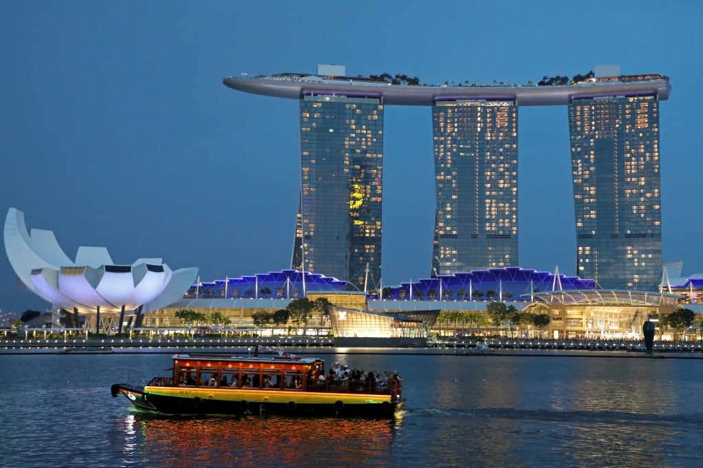 A tourist boat passes by the Marina Bay Sands hotel in Singapore. The city’s hotels enjoyed a bumper July amid the protests in Hong Kong, where hotel operators report booking cancellations and event organisers have switched venues to Singapore. Photo: Reuters