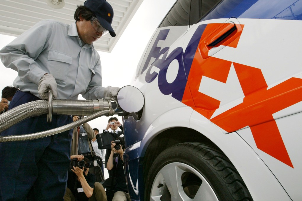 The “HydroGen 3" fuel-cell vehicle being refuelled with hydrogen in Tokyo on July 9, 2003, the first such vehicle in Japan to receive a “green” commercial number plate. FedEx will use the vehicle on its regular delivery routes in a one-year collaboration with General Motors. Photo: Reuters