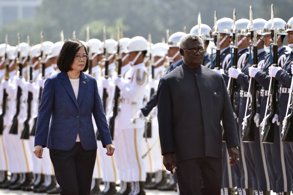 Solomon Islands Prime Minister Manasseh Sogavare and Taiwanese President Tsai Ing-wen inspect an honour guard in Taipei in 2017. Photo: AFP