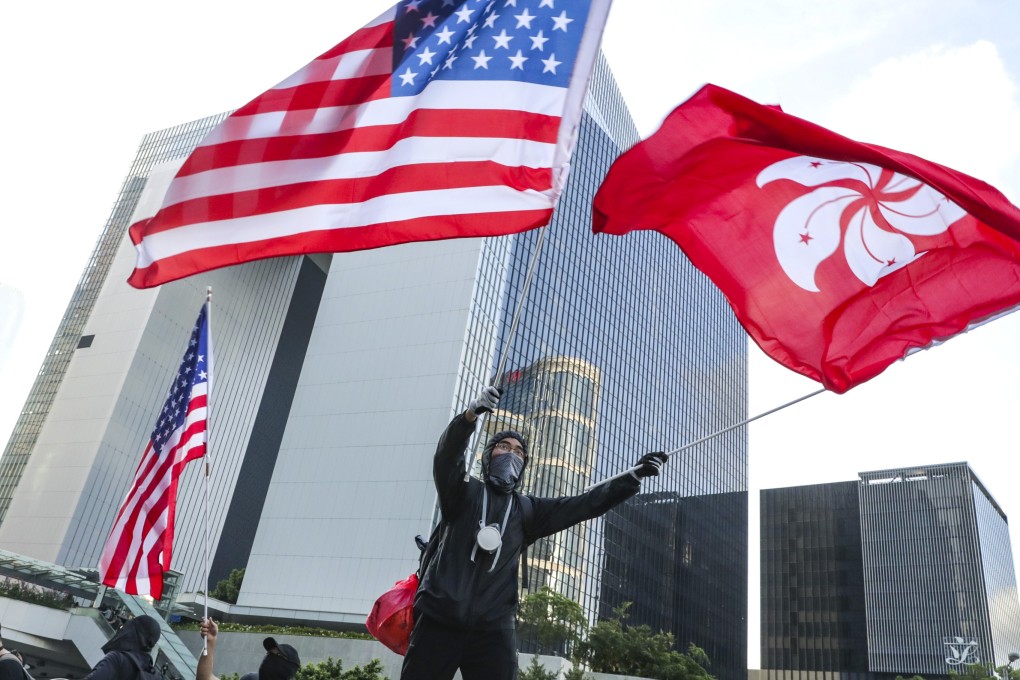 A protester waves the American and Hong Kong flags during a march on July 21. Photo: Edmond So