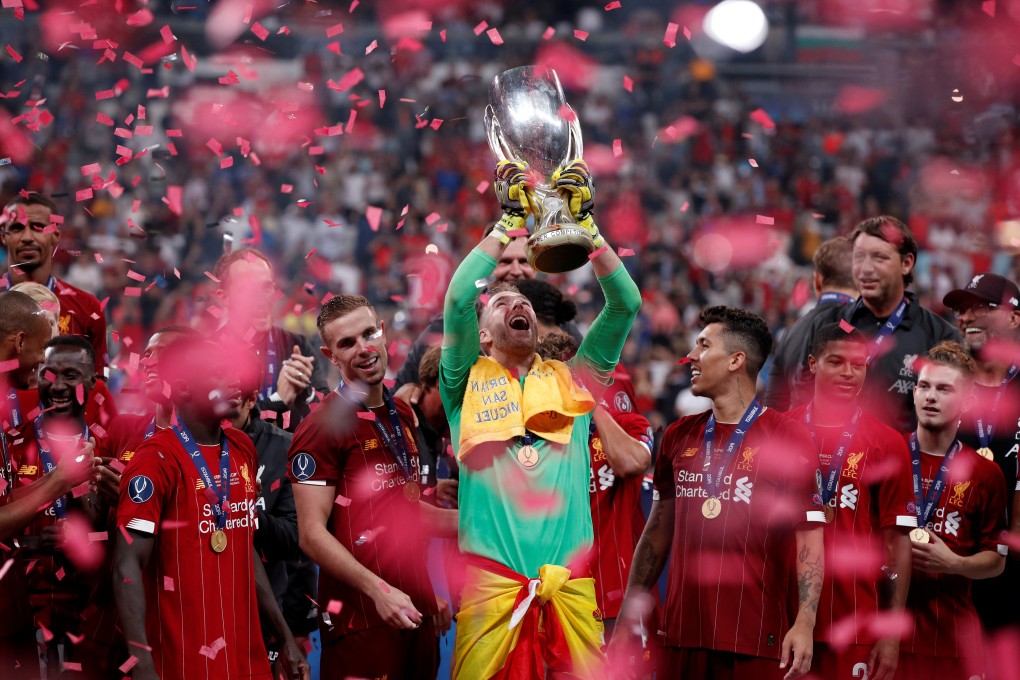 Liverpool's Adrian lifts the trophy as he celebrates winning the Uefa Super Cup with teammates. Photo: Reuters