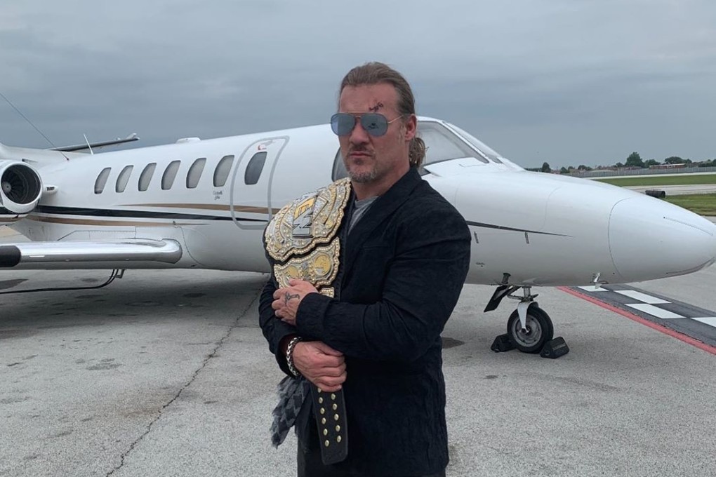 Chris Jericho poses with the AEW world title belt outside a private jet. Photo: Instagram/Chris Jericho