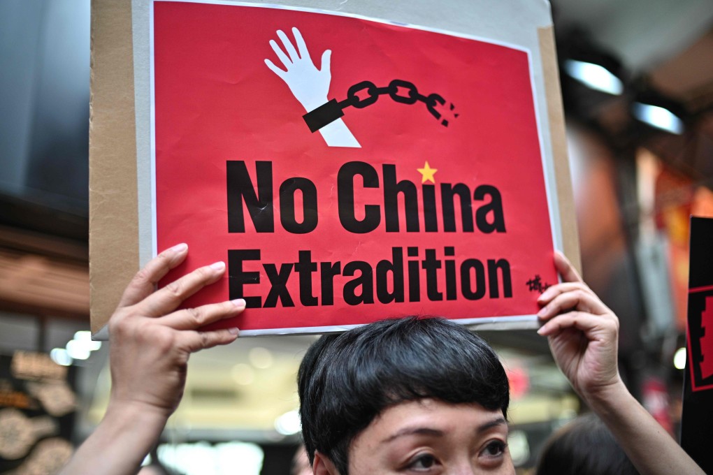 A protester holds an anti-extradition bill placard at a demonstration on April 28. Photo: AFP