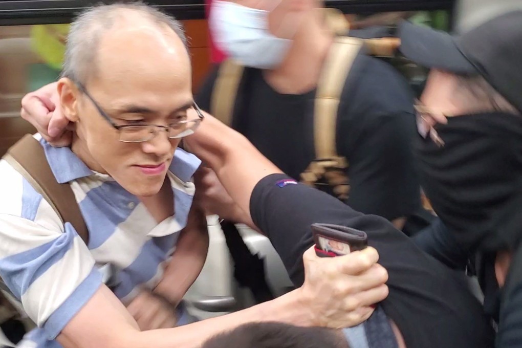 A protester attacks the station supervisor at Po Lam MTR station. Photo: Chris Lau