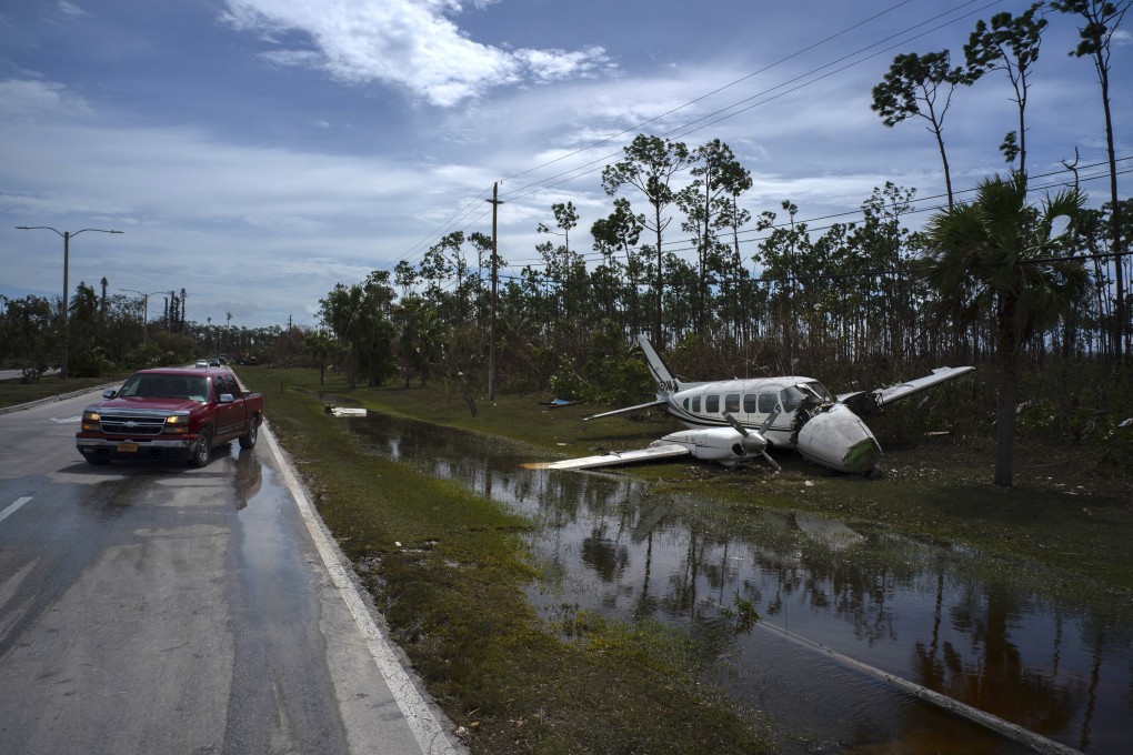 An airplane sits on the side of a road in the Pine Bay neighborhood in Freeport, Bahamas, in the aftermath of Hurricane Dorian. Photo: AP