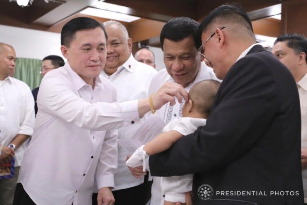Senator Lawrence “Bong” Go, President Rodrigo Duterte, and Bureau of Corrections chief Nicanor Faeldon at the baptism of Faeldon’s son. Photo: Handout