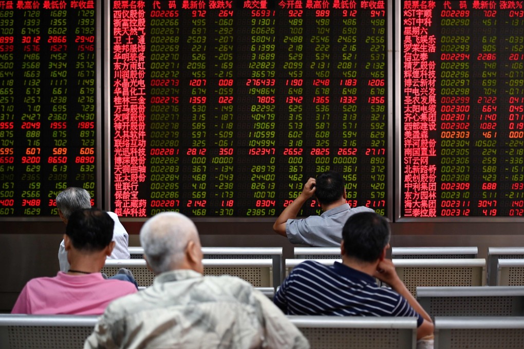 Investors rest on a chair in front of screens showing stock market movements at a securities company in Beijing. Chinese shares had their best week since June 21. Photo: AFP