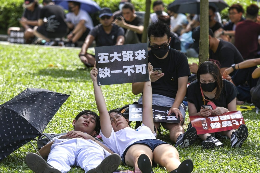 Protesters sneak a nap during a rally to support striking students at Tamar Park on Tuesday. Photo: Tory Ho