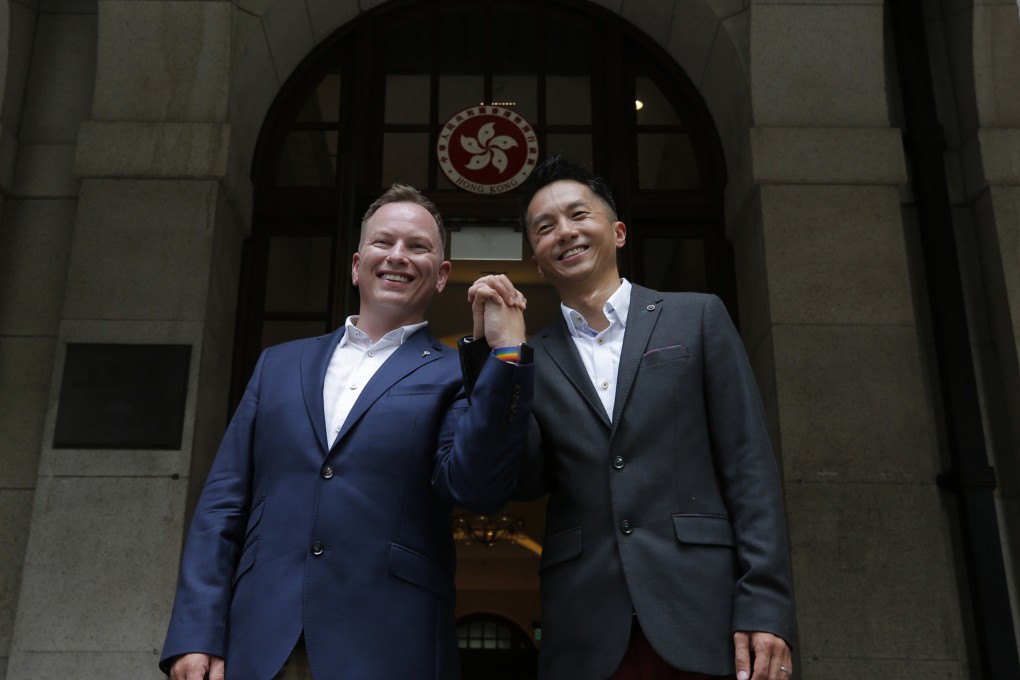 Scott Adams and Angus Leung (right) won their court battle in June 2019. A judge on Friday urged the government to backdate the benefits they and colleagues are now entitled to. Photo: AP