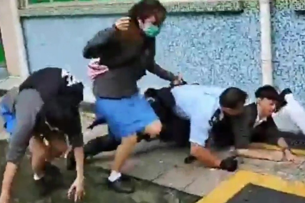 A student was injured when a police officer chased him outside Confucian Tai Shing Ho Kwok Pui Chun College in Tai Po on Tuesday. Photo: Handout