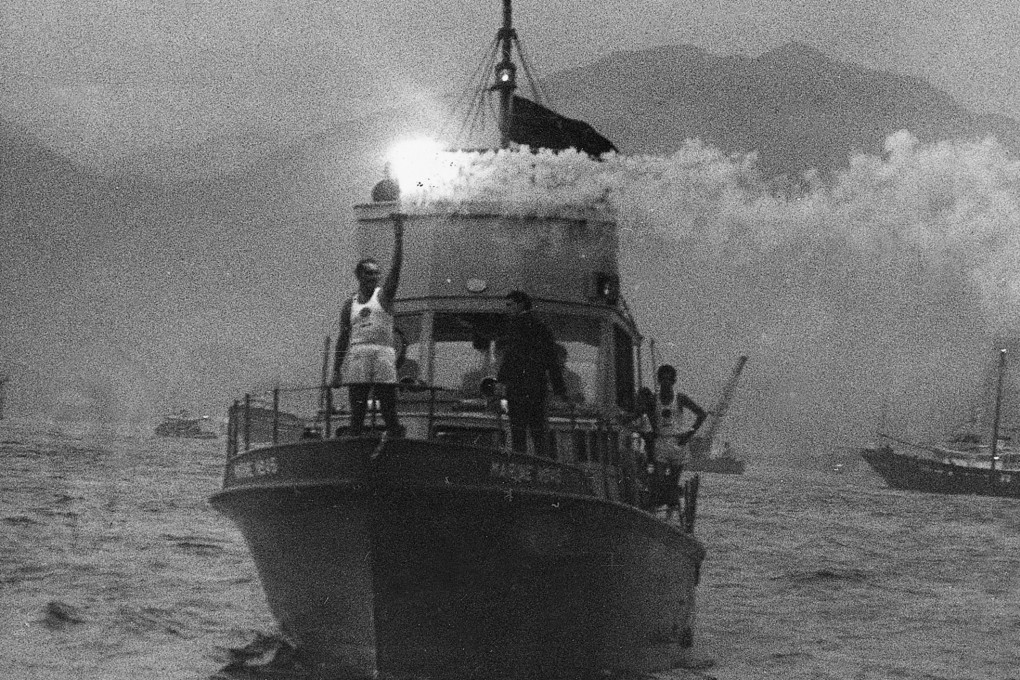 The Olympic torch, carried by runner J.M. Park, crosses Victoria Harbour on a boat, in 1964. Photo: China Mail