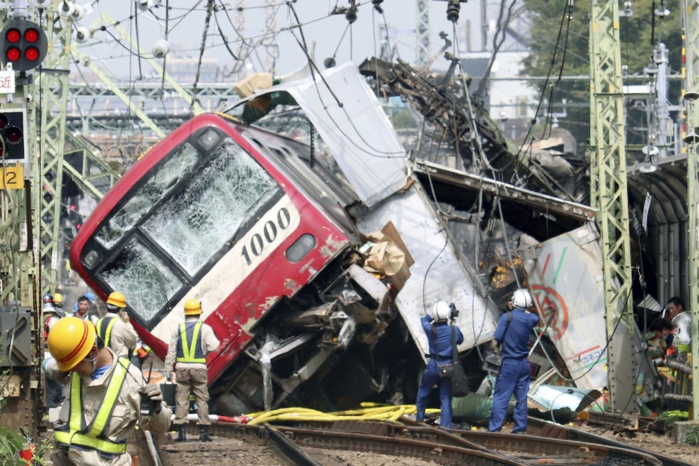 A train sits derailed after a collision with a truck in Yokohama, near Tokyo. Photo: AP