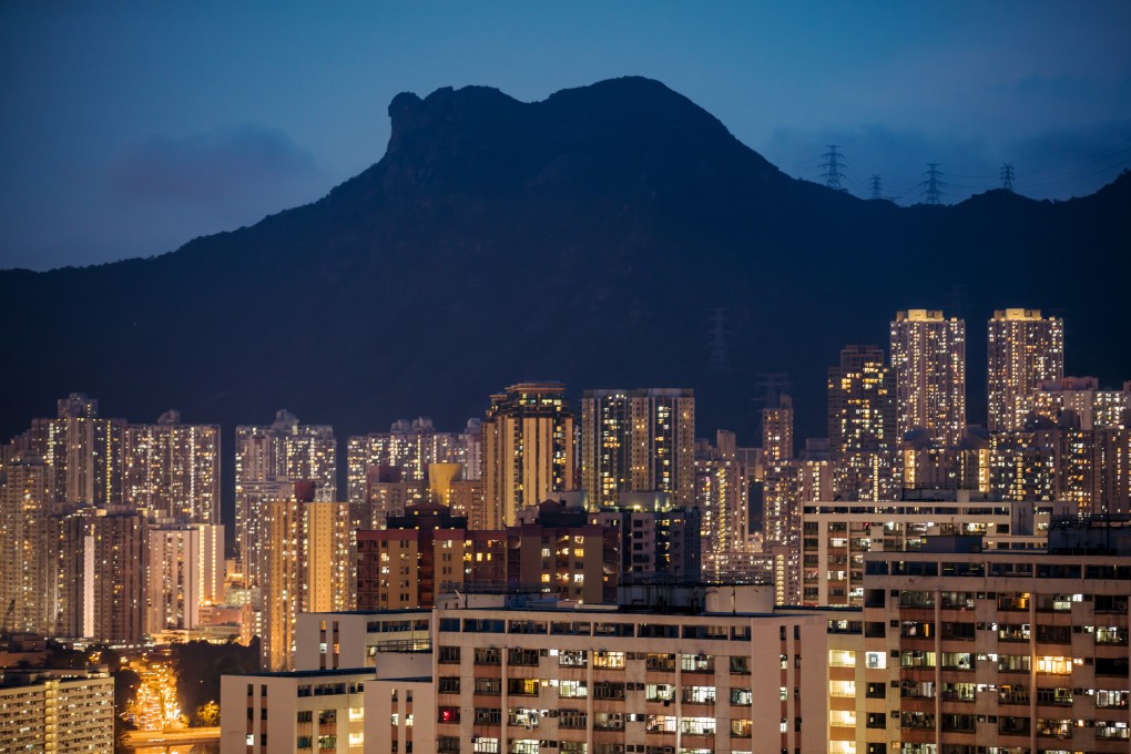 Residential buildings stand illuminated under Lion Rock at dusk in Hong Kong on July 21, 2018. Photo: Bloomberg