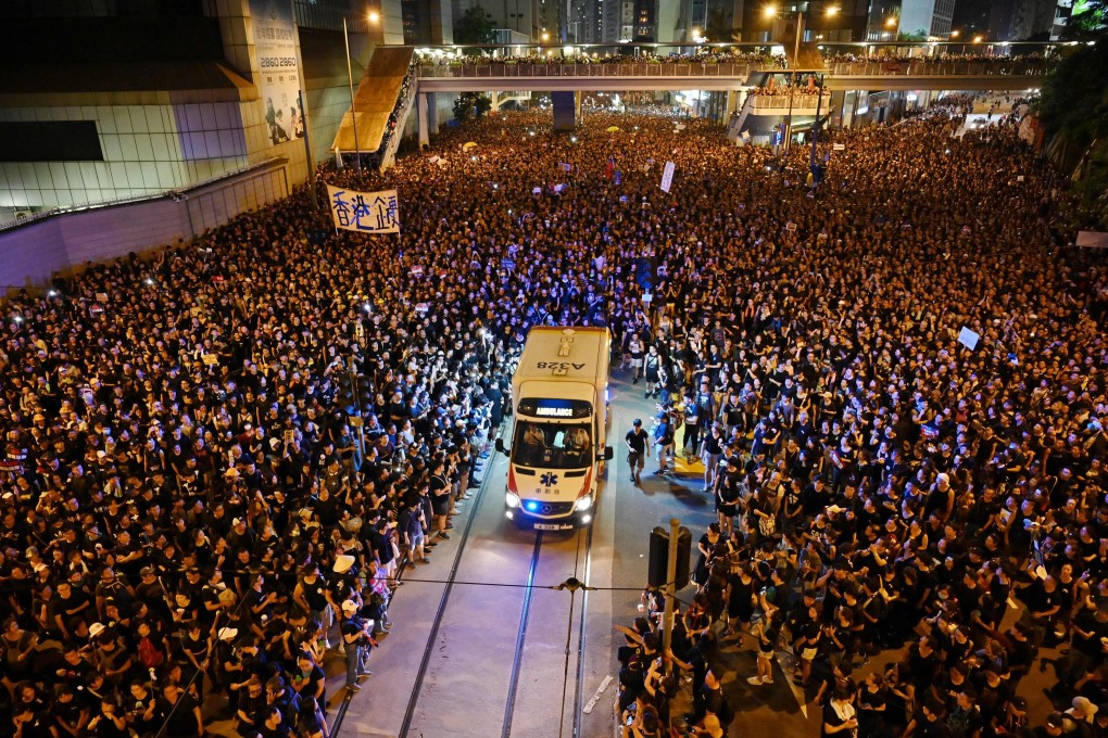 A crowd parts to allow an ambulance through during a mass rally in Hong Kong. Photo: AFP