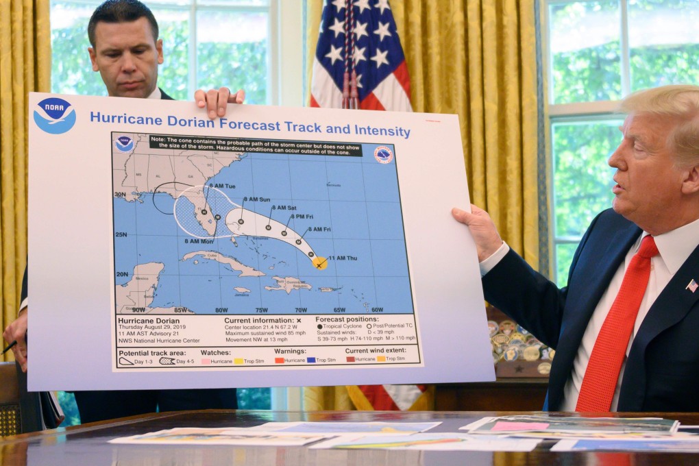 US President Donald Trump brandishes a doctored weather map showing an out-of-date forecast for Hurricane Dorian. Photo: AFP