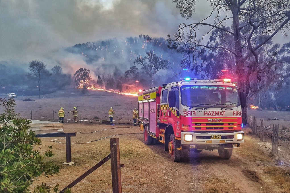 Firefighters extinguish a large bush fire in northern New South Wales. Photo: dpa
