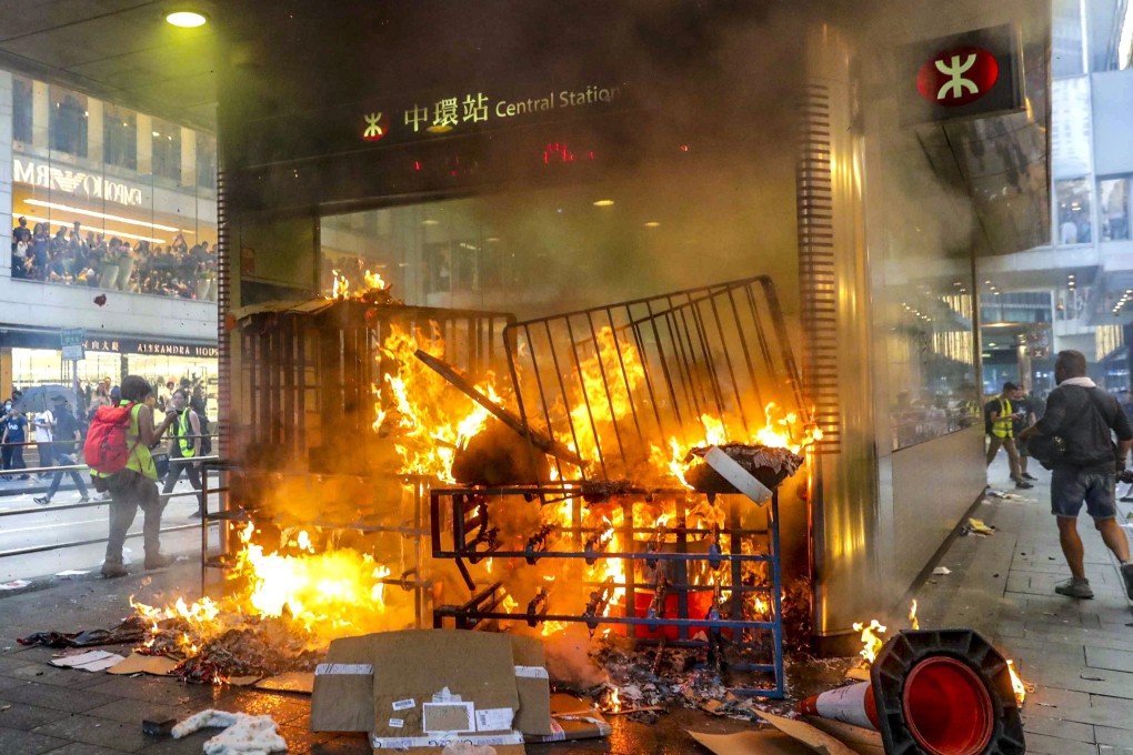 Protesters set fire to an entrance of Central MTR Station as Sunday’s demonstrations turn ugly. Photo: Edmond So