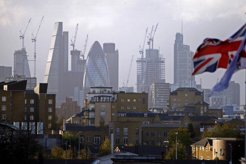 Construction cranes stand near skyscrapers in the City of London. Applications for so-called tier-1 investor visas to the UK by ultra-wealthy Chinese jumped by more than half in the first quarter of 2019. Photo: AFP