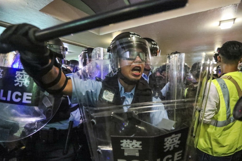Police push protesters away after a march against parallel trading by mainland Chinese visitors in Sheung Shui on July 13. Photo: Felix Wong