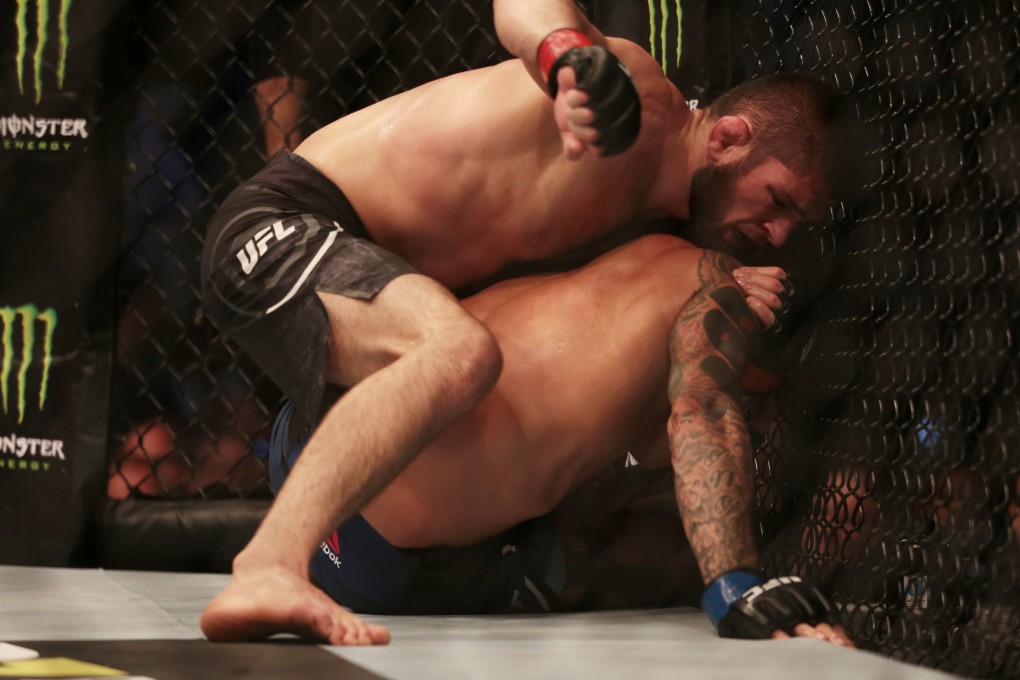 Khabib Nurmagomedov punches Dustin Poirier from the top. Photo: Reuters