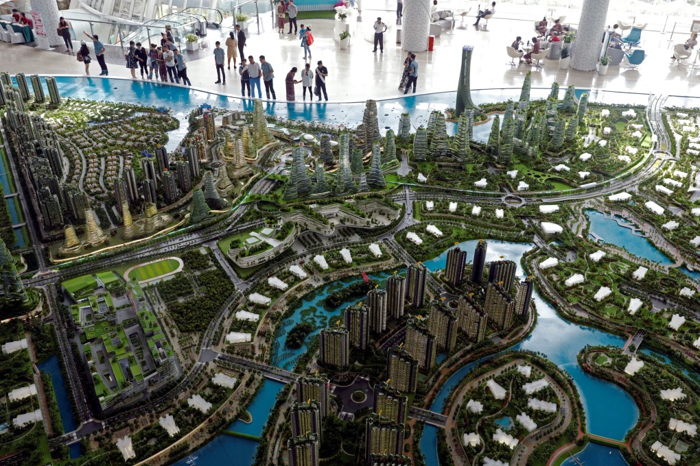 Prospective buyers look at a model of Country Gardens’ Forest City at a showroom in Johor Bahru, Malaysia. Photo: Reuters