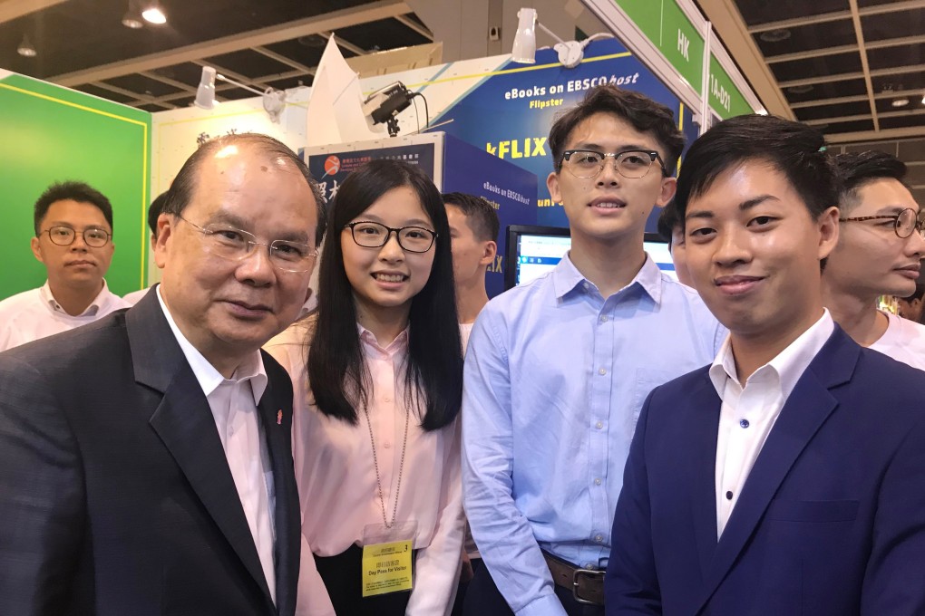Chief Secretary Matthew Cheung poses with two students (centre) who job-shadowed him for a day at the Hong Kong Book Fair in July 2018. Photo: Kimmy Chung