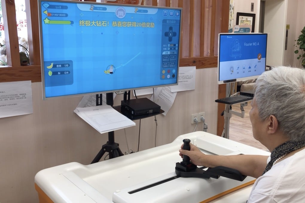 Wang Lingmei, an 84-year-old, sits in front of a rehab machine, playing an electronic game in Lujiazui Elderly Community Centre. Photo: Minghe Hu