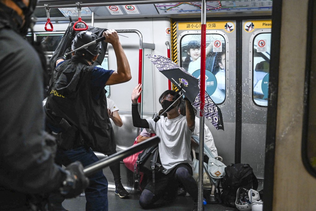 Members of the Special Tactical Squad enter a stationary train at Prince Edward station. Photo: Handout