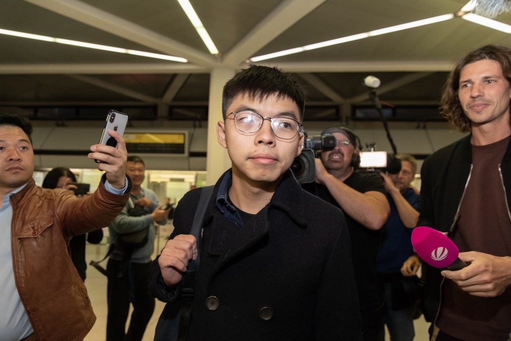 Hong Kong activist Joshua Wong (centre) arrives at Tegel Airport in Berlin on Monday. Photo: EPA-EFE