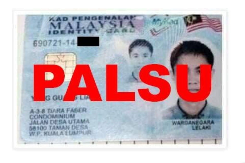 Fake Malaysian identification cards with pictures of alleged Chinese nationals. Photo: National Registration Department/Facebook
