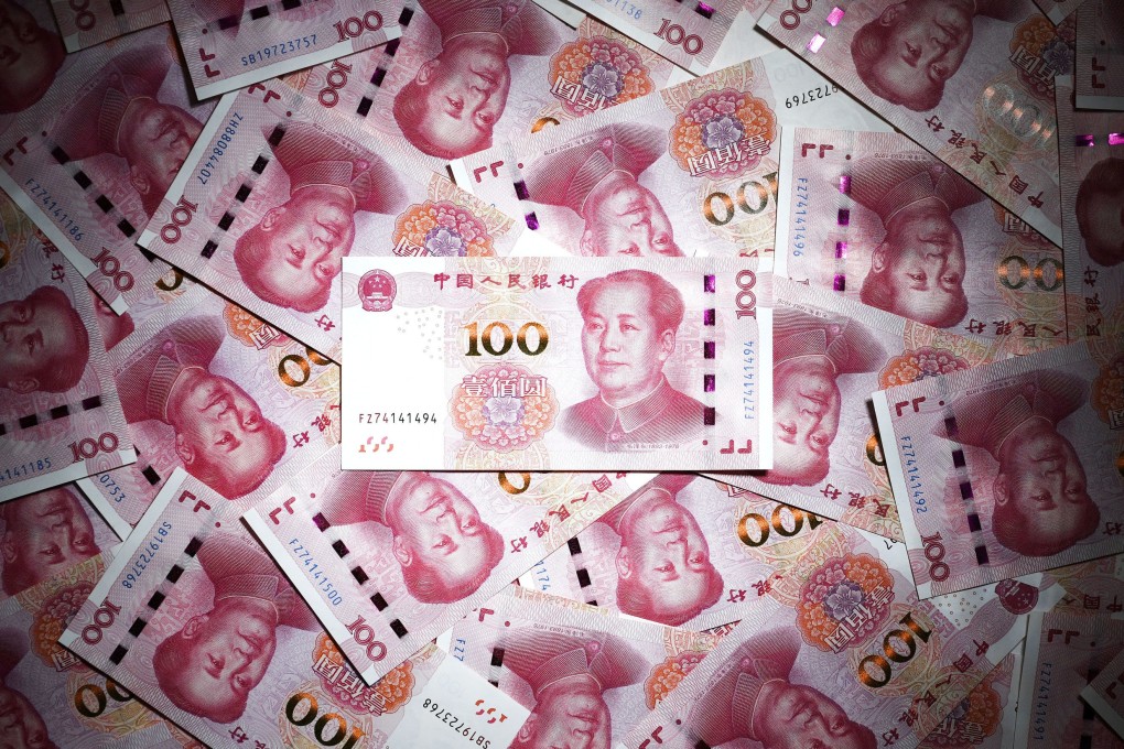 Bundles of 100 yuan notes are pictured at a bank in Shanghai. The People’s Bank of China (PBOC) is expected to join a global monetary easing cycle led by the US Federal Reserve and the European Central Bank. Photo: Kyodo