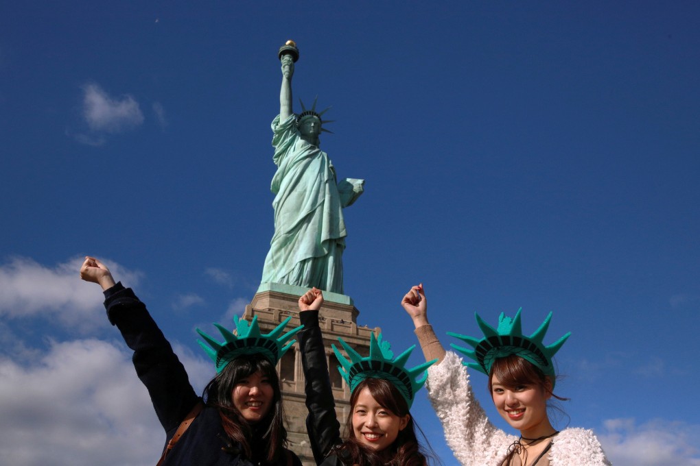 Japanese tourists at the Statue of Liberty, in New York City, in the United States. Photo: Reuters