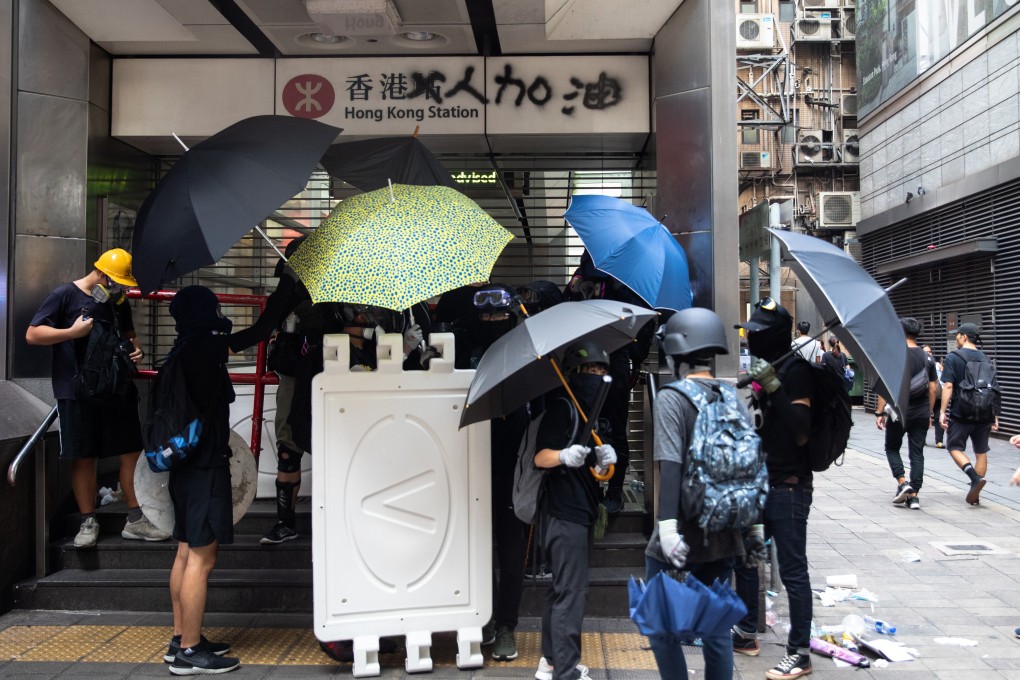 Demonstrators stand in front of a shuttered entrance to Hong Kong station during a protest on September 8. Photo: Bloomberg