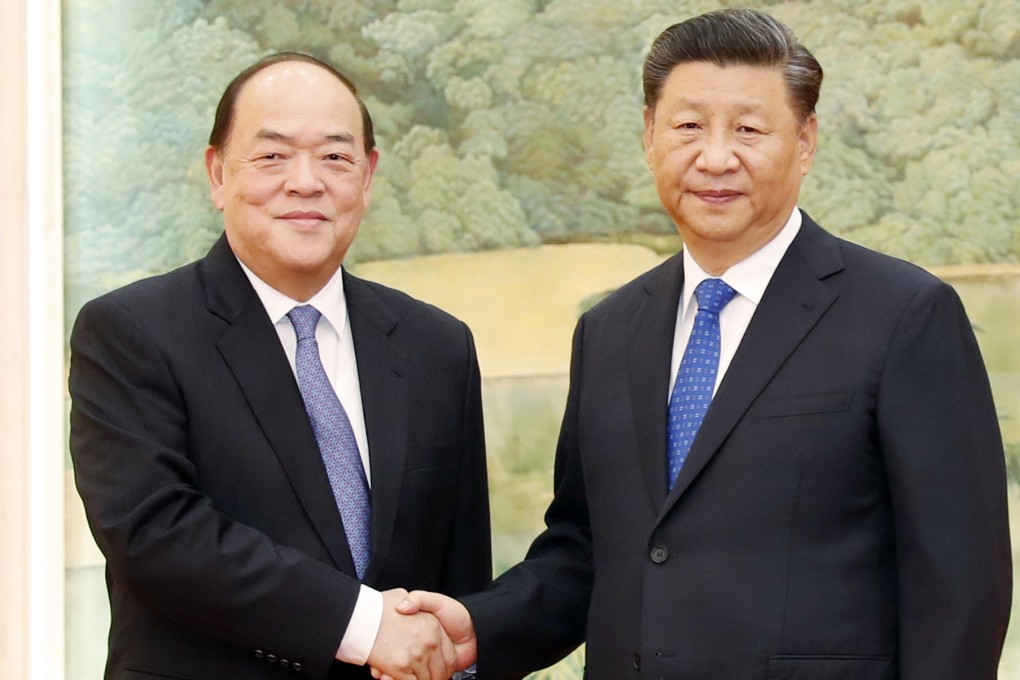 Xi Jinping shakes hands with Ho Iat-seng in Beijing on Wednesday. Photo: Handout