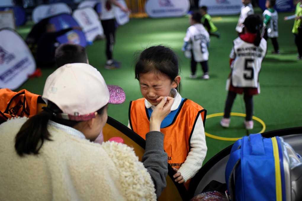 A girl cries during a training session at a youth rugby club in southwest China. Rugby is considered to be a ‘rough sport’ in China and has struggled to get a foothold. Photo: AFP